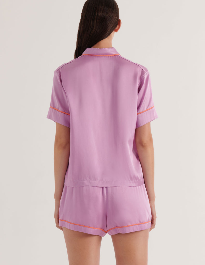 Back of person wearing a mauve with orange trim Araks Shelby Pajama top and matching Tia Boxer on a white background
