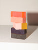 Araks Stack of colorful handmade soap bars on a neutral background