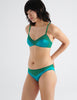 three quarter view of woman in green silk bra and panty