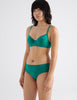 Three quarter view image of model wearing green recycled organic cotton hipster panty with matching underwire bra