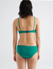 Back view image of model wearing green recycled organic cotton hipster panty with matching underwire bra