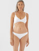 On model image of white, organic cotton thong and bra. 