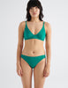 Front view image of model wearing green recycled organic cotton bralette with matching panty