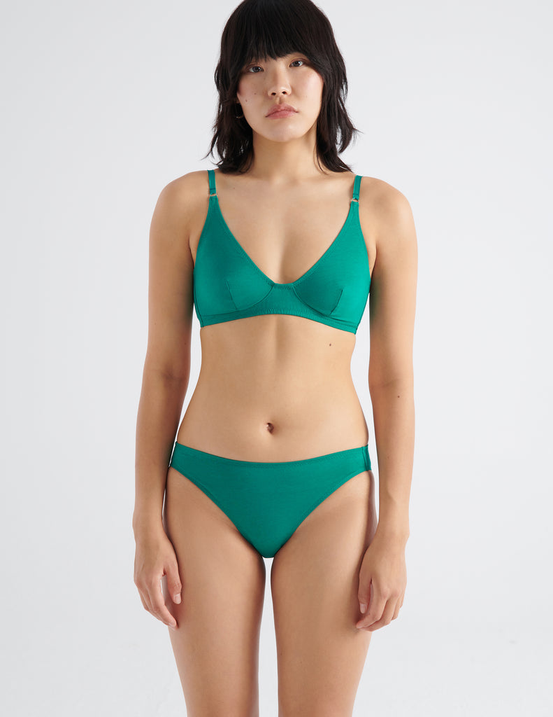 Front view image of model wearing green recycled organic cotton panty with matching bralette