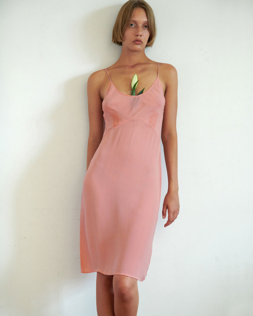 woman in pink silk cadel slip