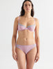 Front view image of model wearing a pair of cotton crepe panties in a soft purple color with matching underwire bra. 