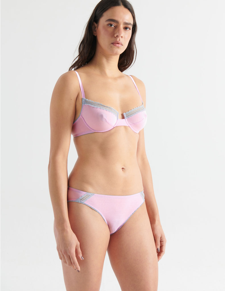 Three quarter view image of model wearing a pair of cotton crepe panties in a soft purple color with matching underwire bra. 
