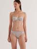 a model in the araks cotton crepe chloe underwire bra and sonja panty in mist blue grey