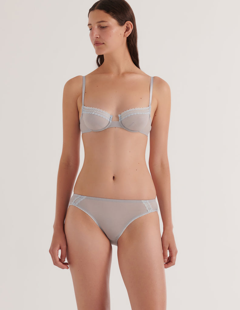 a model in the araks cotton crepe chloe underwire bra and sonja panty in mist blue grey