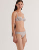 a model in the araks chloe underwire cotton crepe bra and sonja panty in mist grey blue