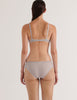 a back view of a model in the araks cotton crepe chloe underwire bra and sonja panty in mist blue grey