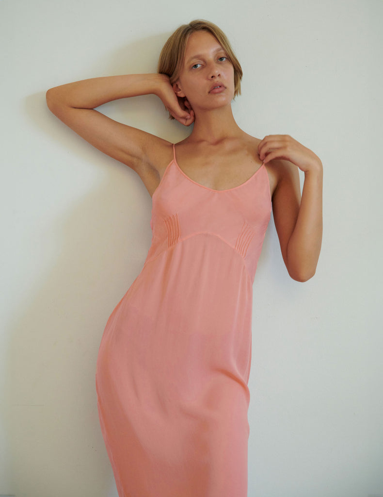 woman in pink silk cadel slip
