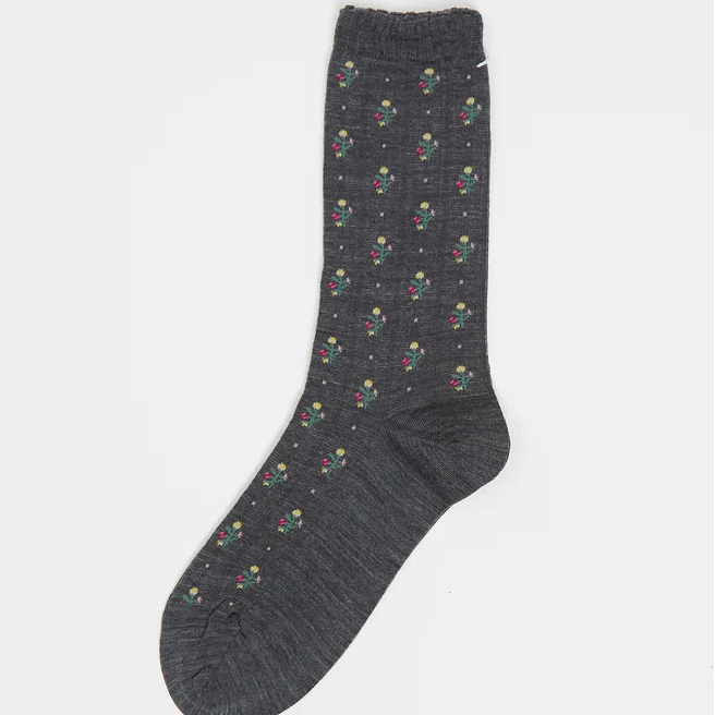 Dark gray sock with colorful pattern on a light gray background