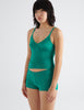 three quarter front view image of model wearing green lace cami top and boy short