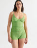 Front view image of model wearing green lace cami top with matching shorts. 