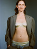 Model wearing Gita silk bralette in front of a grey background. Styled with a large blazer and matching silk panty. 