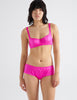 Front view on model of pink silk bra and panty