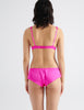 On model image of back of pink silk bra and pink silk panty