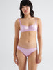 Front view om model wearing pink silk panty with matching underwire bra. 