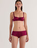 A model in the araks gita underwire bra and gal hipster in cranberry red