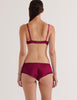 A model in the araks silk gita underwire bra and gal hipster in cranberry red