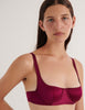 A model in the araks silk gita underwire bra in cranberry red