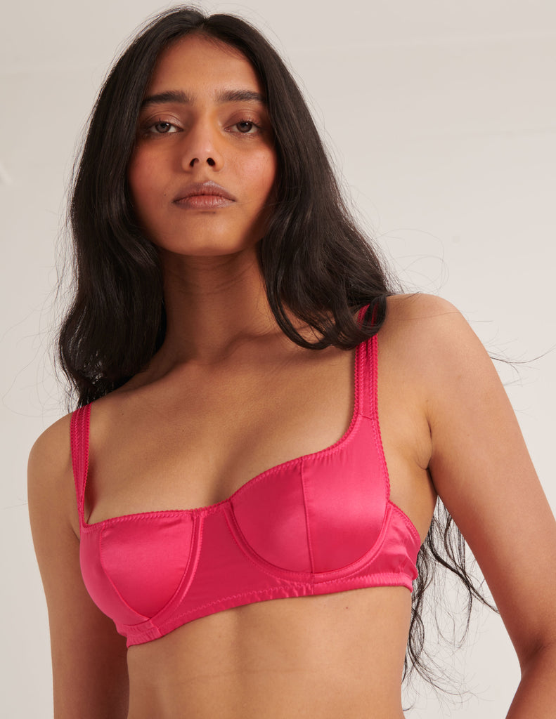 a model wearing the araks gita silk underwire bra in rouge red