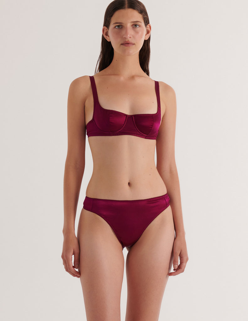 A model in the araks silk gita underwire bra and grier thong in cranberry red