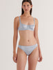 A model in the araks silk gita underwire bra and grier thong in glace blue