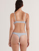 A model in the araks silk gita underwire bra and grier thong in glace blue