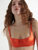Close up view of the woman wearing burst orange silk gita underwire bra 
