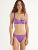 A model in the araks gita underwire bra and gwyneth panty in viola purple