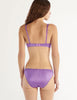 A model in the araks gita underwire bra and gwyneth panty in viola purple