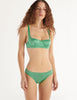 A model in the araks gita underwire bra and gwyneth panty in cypress green