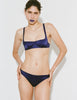A model wearing Araks gita bra and Gwyneth panty in Starling against a plain white studio background.