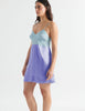 woman in light blue and periwinkle silk slip