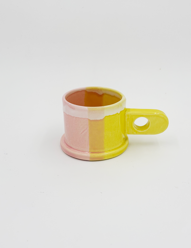 A peter shire pink and yellow dip mug