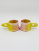 Two peter shire handmade sculptural mugs in yellow and pink