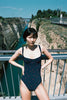 A model posing in the Araks Umi one piece in the shade Lagoon.