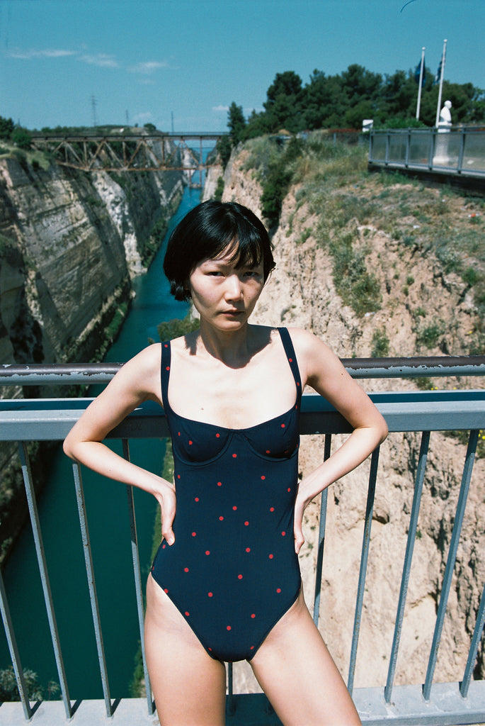 A model posing in the Araks Umi one piece in the shade Lagoon.
