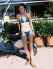 A model in the araks nelle bikini top in fern