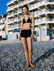 Model wearing Araks Nelle bikini top and Polly swim shorts in navy with red polka dots