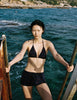Model wearing Araks Nelle bikini top and Polly swim shorts in navy with red polka dots