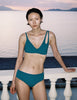 A model in the araks elias bikini top in ezra hipster in fern