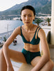 A model in the araks elias bikini top and polly short in fern green