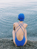 A model in the araks blue tallulah one piece in azure blue