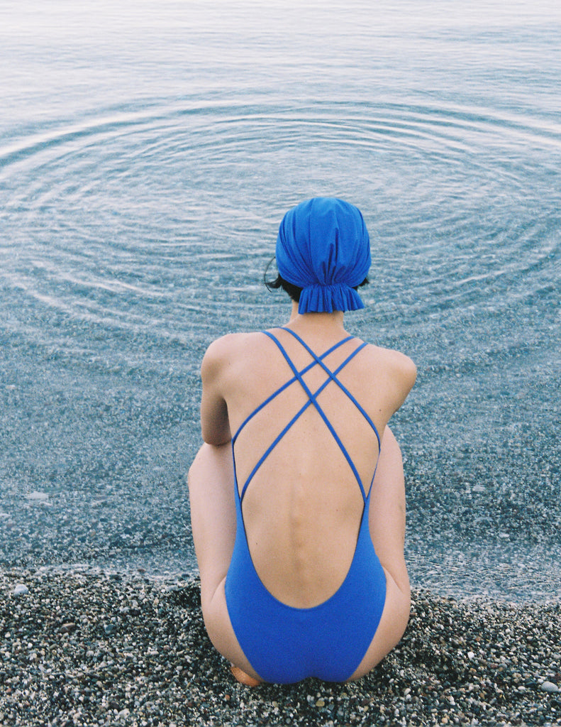 A model in the araks blue tallulah one piece in azure blue