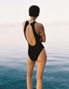 A model in the araks tolle one piece in black