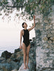 A model in the araks tolle one piece in black