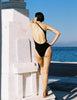 a model wearing a nico one piece in black 